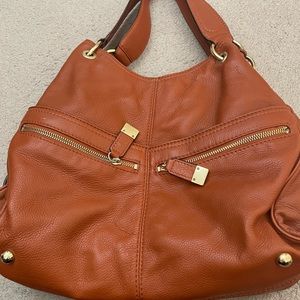 A soft leather Michael Kors bag. Deep rich burnt orange